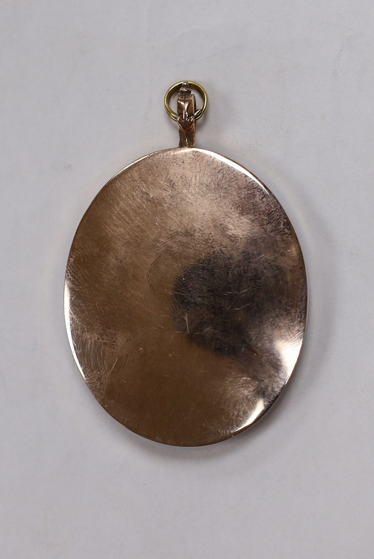 A 19th century portrait miniature, young lady, mounted as a pendant, 4.5x3.5cm